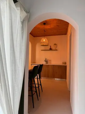 an archway leads into the kitchen and dining room of a house at Pirella House in Limassol