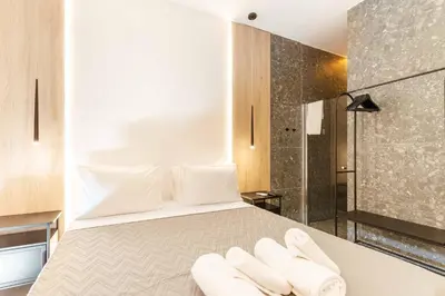 a bedroom with a bed with two white towels at The Secret Yard in Larnaka