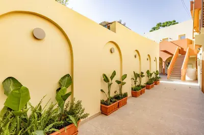 a row of arches on a building with potted plants at The Secret Yard in Larnaka