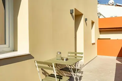 a small table and chairs on a patio at The Secret Yard in Larnaka