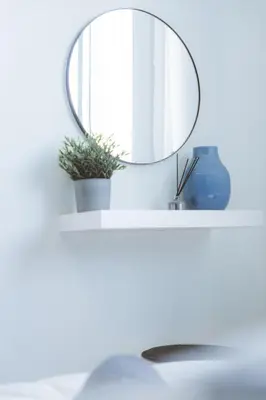 a mirror on a white shelf with a sink at Blue Touch Pervolia Paradise near the beach in Larnaka