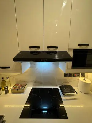 a kitchen with a stove and a counter top at Spacious 1 bedroom flat in Foinikoudes! in Larnaka