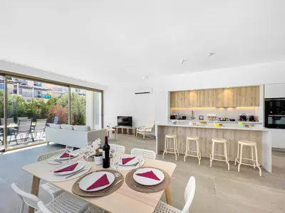 a kitchen and living room with a table and chairs at Azure Seaview - Garnet Villa in Protaras