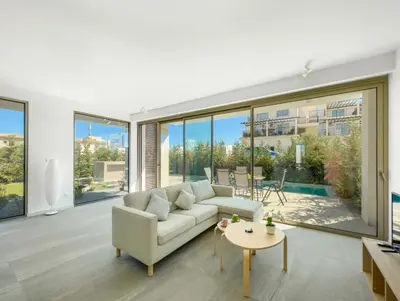 a living room with a couch and a table at Azure Seaview - Garnet Villa in Protaras