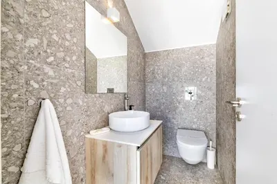 a bathroom with a sink and a toilet at Azure Seaview - Ruby Villa in Protaras