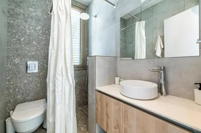 a bathroom with a white sink and a toilet at Azure Seaview - Ruby Villa in Protaras