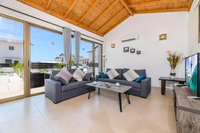 a living room with a couch and a table at Kymma Villa #12 in Ayia Napa