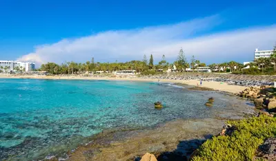 a beach with people swimming in the water at Kymma Villa #12 in Ayia Napa