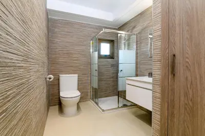 a bathroom with a toilet and a shower and a sink at Kymma Villa #5 in Ayia Napa