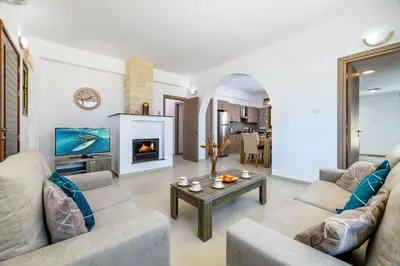 a living room with two couches and a table at Kymma Villa #5 in Ayia Napa