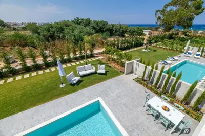 an aerial view of a backyard with a swimming pool at By The Beach - Blue Topaz Villa in Protaras