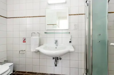 a white bathroom with a sink and a mirror at Sunrise Bay Villa #5 in Protaras