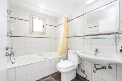 a bathroom with a toilet and a sink and a tub at Sunrise Bay Villa #6 in Protaras