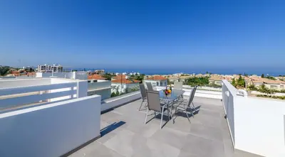 a balcony with a table and chairs on a roof at Mylos Lifestyle Seaview Villa #15 in Protaras