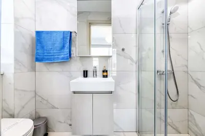 a white bathroom with a shower and a sink at Mylos Lifestyle Seaview Villa #37 in Protaras