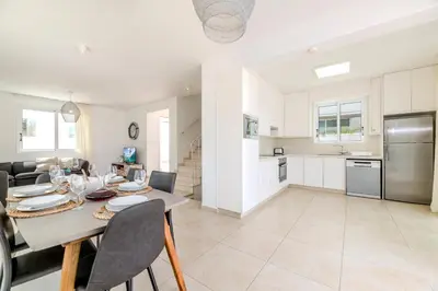 a kitchen and dining room with a table and chairs at Green Bay Villa #14 in Protaras