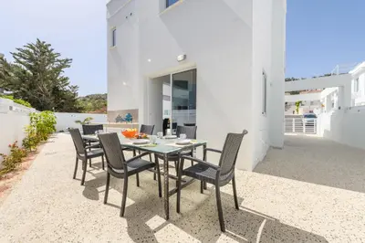 a table and chairs on the patio of a house at Green Bay Villa #15 in Protaras
