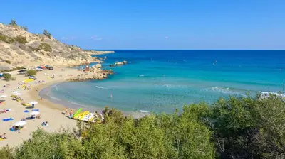 a group of people on a beach with the ocean at Green Bay Villa #15 in Protaras
