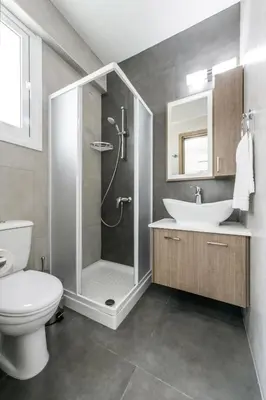 a bathroom with a shower and a toilet and a sink at Green Bay Villa #17 in Protaras