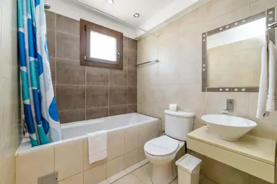 a bathroom with a toilet and a tub and a sink at Villa Greco Mare #6 in Protaras