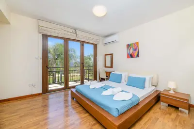 a bedroom with a bed and a large window at Villa Greco Mare #6 in Protaras