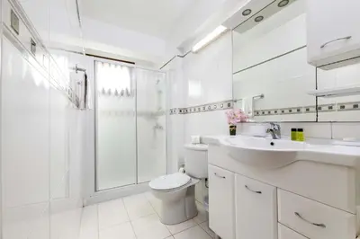 a bathroom with a toilet and a shower and a sink at Villa Greco Mare #20 in Protaras