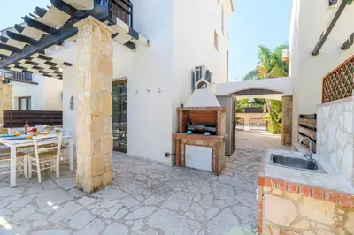 a kitchen and dining area of a house with a stove at Villa Greco Mare #40 in Protaras