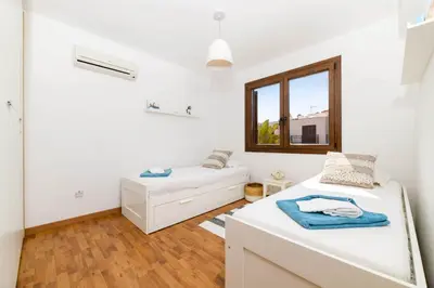 a white room with two beds and a window at Villa Greco Mare #40 in Protaras