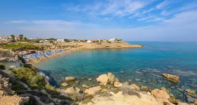 a beach with a bunch of people in the water at Villa Clementine in Protaras