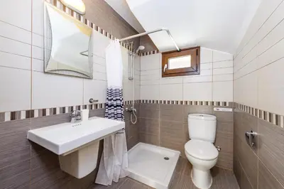a bathroom with a toilet and a sink at Hanns Villa in Protaras