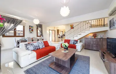 a living room with a couch and a table at Hanns Villa in Protaras