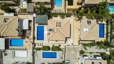 an overhead view of houses with blue roofs at Villa Hannah in Protaras