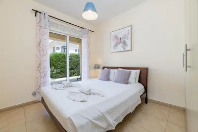 a bedroom with a large bed and a window at Villa Hannah in Protaras