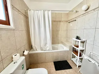 a bathroom with a tub and a toilet and a shower at STAY Tranquility Cove in Larnaka
