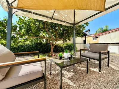 a patio with a table and an umbrella at STAY Tranquility Cove in Larnaka