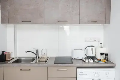 a kitchen with a sink and a counter top at Quattro City Center Ap 501B in Larnaka