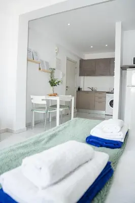 a kitchen with a table with towels on the floor at Quattro City Center Ap 501B in Larnaka