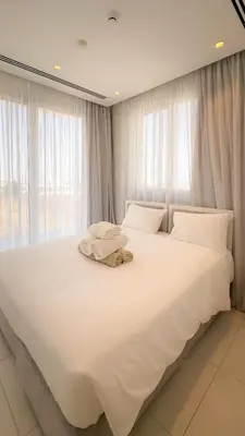 a large white bed with white sheets and pillows at City Napa Seaview Villas - Villa 5 in Ayia Napa