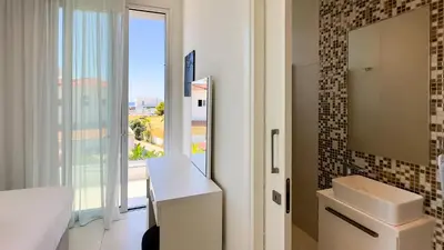 a bathroom with a toilet and a window with a view at City Napa Seaview Villas - Villa 6 in Ayia Napa
