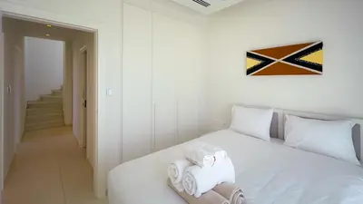 a bedroom with a white bed with towels on it at City Napa Seaview Villas - Villa 6 in Ayia Napa