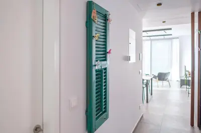 a room with a green shutter on the wall at Gaia Seaview Apartment 2 in Larnaka