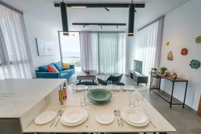 a living room with a table with plates on it at Gaia Seaview Apartment 2 in Larnaka