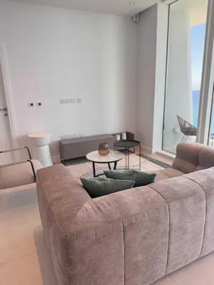 a living room with a couch and a table at Ayia Napa Marina Exclusive Apartment in Ayia Napa