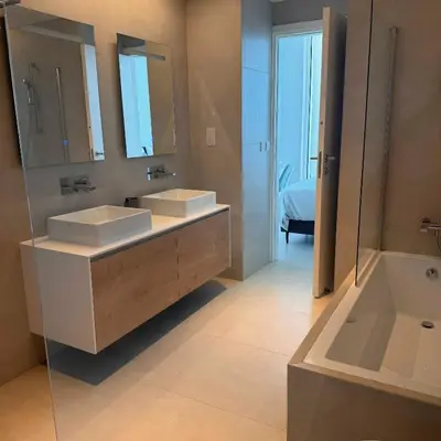 a bathroom with two sinks and a mirror and a tub at Ayia Napa Marina Exclusive Apartment in Ayia Napa
