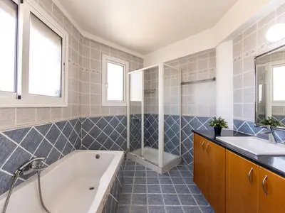 a bathroom with a tub and a sink at Villa Alexandra in Protaras