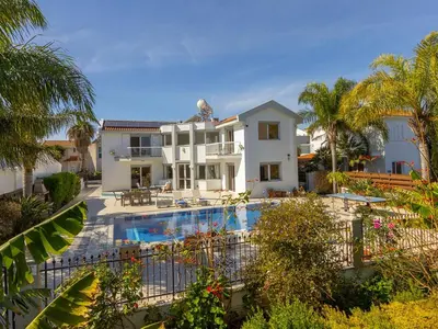 a large house with a swimming pool in front of it at Villa Alexandra in Protaras