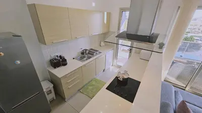 a small kitchen with a sink and a refrigerator at STAY White Petals Apartment in Larnaka
