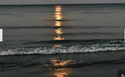 a reflection of the sun in the water on the beach at KAMILA 5 in Voroklini