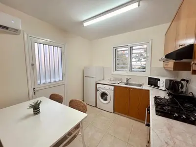 a kitchen with a washer and dryer in it at KAMILA 5 in Voroklini