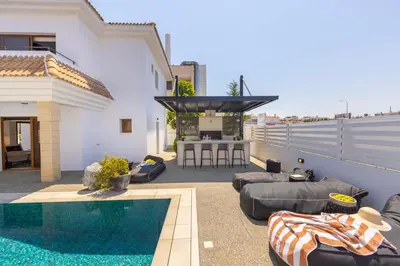 a backyard with a swimming pool and a house at SunnyVillas-3BR New Modern Villa-Private Pool-HVN in Paralimni